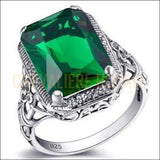 Chevalière femme argent pierre émeraude étayée par quatre griffes